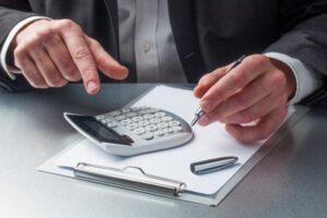 A person calculating on a clipboard