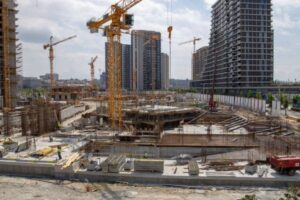 A large construction site with cranes and building structures under development