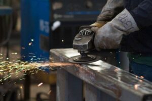 Worker using a grinding tool on metal