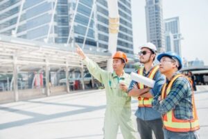 Engineers discussing plans at a modern construction site.