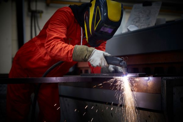 Worker using steel fabrication for cutting