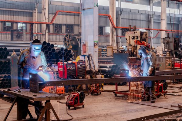 Workers in a steel fabrication facility
