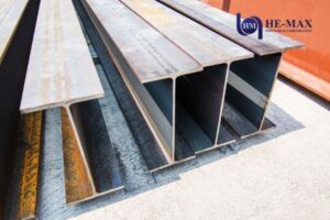 Close-up of steel I-beams stacked outdoors