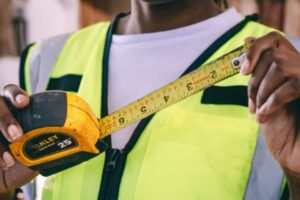 Person measuring with a tape measure.