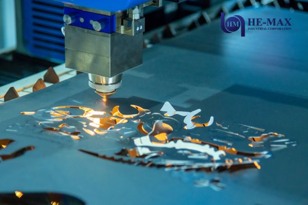 A laser cutting machine in operation, precisely cutting through a sheet of metal.
