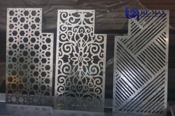 Three distinct metal decorative panels showcasing varied designs and textures
