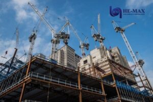High-rise building construction with tower cranes and steel framework