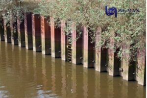Steel sheet pile retaining wall installed along riverbank