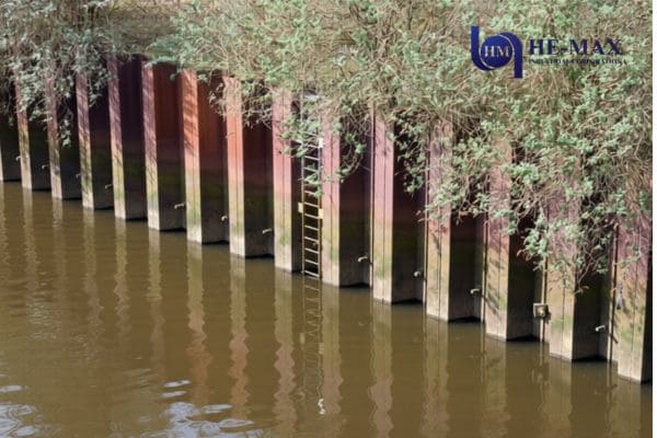 Steel sheet pile retaining wall installed along riverbank
