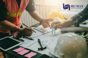 construction team planning blueprints tools desk
