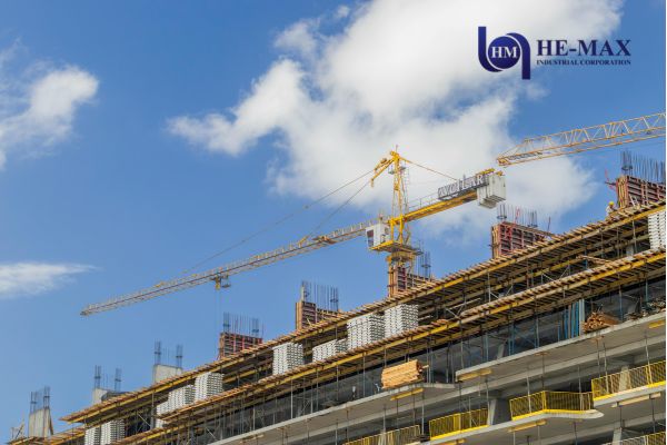 Construction crane towering over a building in progress, emphasizing the need for quality steel fabrication.