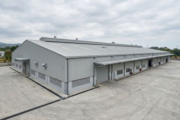 warehouse with gi sheets Industrial building featuring a large garage, associated with GI Sheets Philippines.